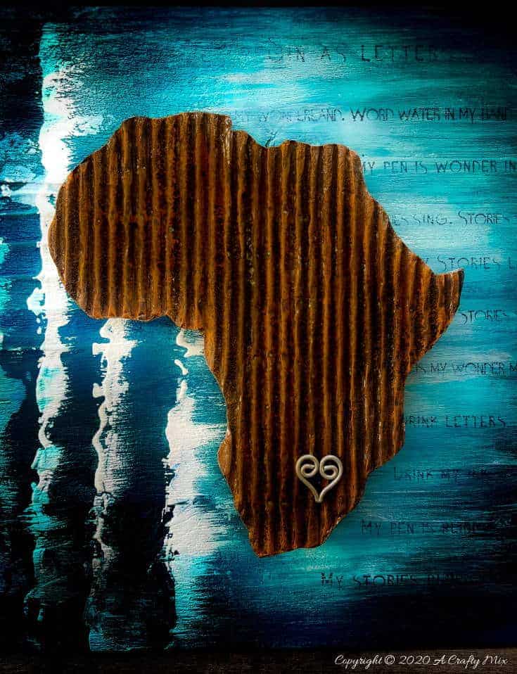 Mixed media pieces are always fun to put together and the possibilities are endless. This tutorial will show you how to make cardboard look like a rusty sheet of metal and turn your mixed media into a night light. #mixedmedia #mixedmediatutorial #DIYNightLight #ACraftyMix #fauxrust #Africa #HomeDecor