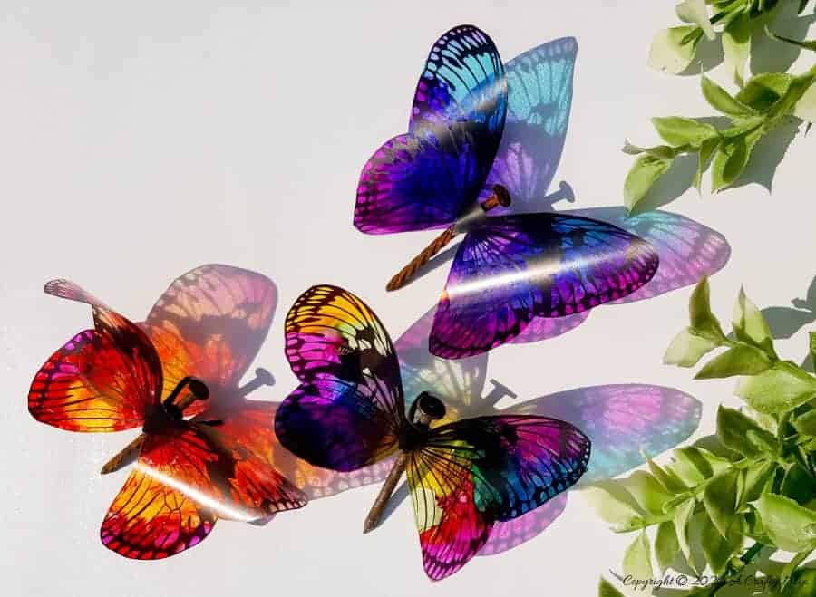 Rusty nails have never looked more beautiful with these translucent butterfly wings. Full tutorial includes 2 free printables to make the butterfly wings and/dragonfly wings. #DragonflyWingsTemplate #DragonflyWingsDIY #ButterflyWings #ACraftyMix #DIYDragonflyWings #AlcoholInkCrafts #AlcoholInk #CraftTutorial