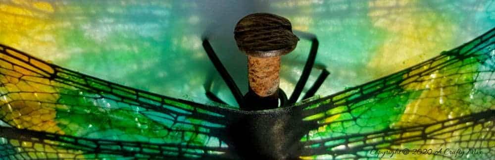 A rusty nail has never looked more gorgeous with these translucent dragonfly wings. Full tutorial includes 2 free printables to make dragonfly and butterfly wings. #DragonflyWingsTempalte #DragonflyWingsDIY #ButterflyWings #ACraftyMix #DIYDragonfltWings #AlcoholInkCrafts #AlcoholInk #CraftTutorial