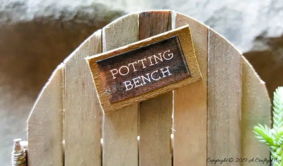 Make this adorable fairy potting bench using rusty nails and stirrer sticks. Quick and easy craft idea for your miniature garden #FairyPottingBench #FairyDIYCrafts #ACraftyMix #FairyGardens #FairyCrafts #WhimsicalFairyCrafts #SimpleFairyCrafts #MiniaturePottingBench #RustyNails