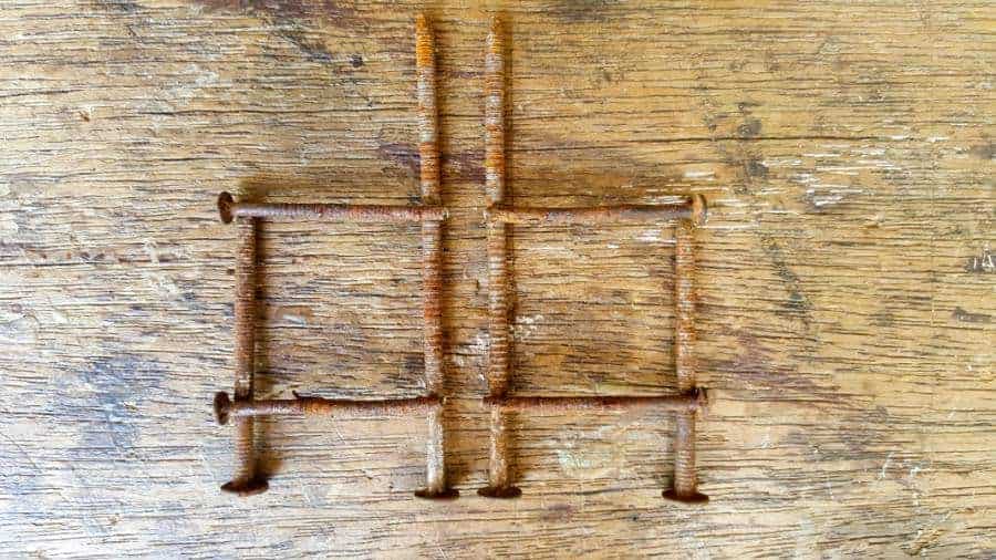 Glue the rusty nails together to form a frame #FairyPottingBench #FairyDIYCrafts #ACraftyMix #FairyGardens #FairyCrafts #WhimsicalFairyCrafts #SimpleFairyCrafts #MiniaturePottingBench #RustyNails