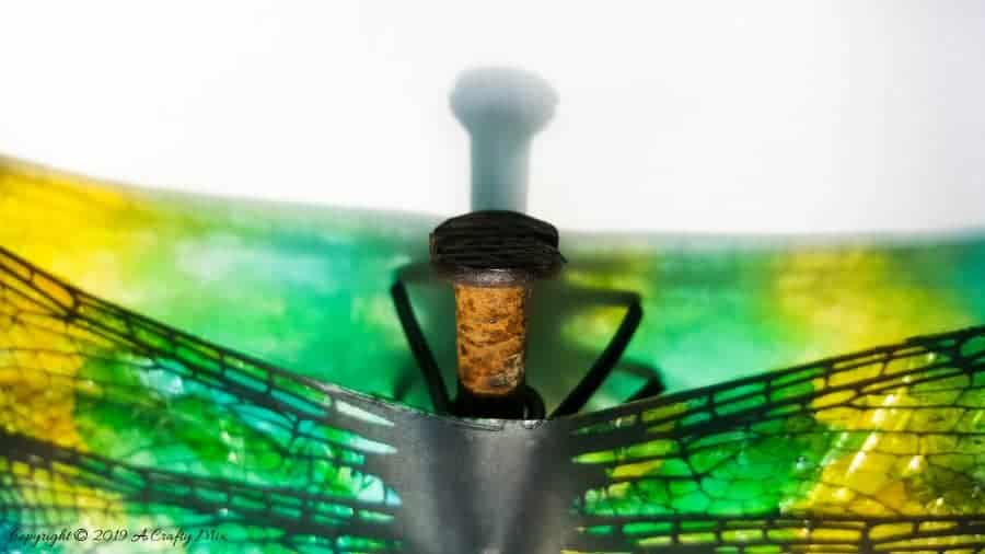 A rusty nail has never looked more gorgeous with these translucent dragonfly wings. Full tutorial includes 2 free printables to make dragonfly and butterfly wings. #DragonflyWingsTempalte #DragonflyWingsDIY #ButterflyWings #ACraftyMix #DIYDragonfltWings #AlcoholInkCrafts #AlcoholInk #CraftTutorial