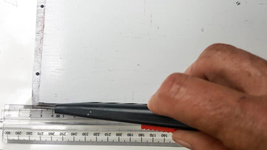 Trim the Chinioserie vinyl tiles with a craft knife or a pair of scissors #ChinoiserieDecor #VinylTile #EasyMakeOver #HomeDecorDIY #chinoiserietiles #ACraftyMix #blueandwhitedecor #chinoiseriechic #VinylTileDecor #DIYTutorial