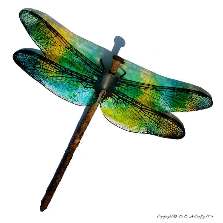 A rusty nail has never looked more gorgeous with these translucent dragonfly wings. Full tutorial includes 2 free printables to make dragonfly and butterfly wings. #DragonflyWingsTemplate #DragonflyWingsDIY #ButterflyWings #ACraftyMix #DIYDragonflyWings #AlcoholInkCrafts #AlcoholInk #CraftTutorial