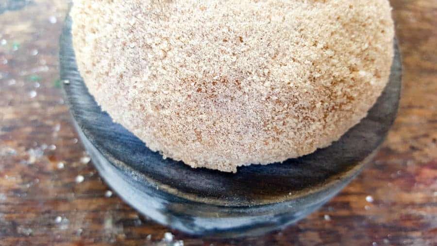 Adding the beach sand to the fairy garden cloche #FairyGarden #FairyGardenIdeas #ACraftyMix #FairyGardenDIY #FairyBeachDIY #FairyGardenDesigns #ClocheDecor #ClocheIdeas #WineGlassCloche #ClocheDIY #WineGlassRepurpose #UnicornSPiT