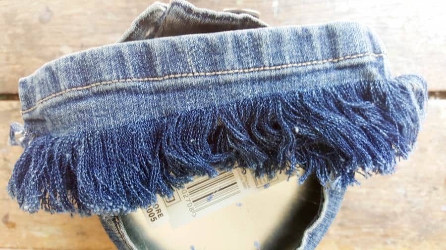 Add a strip of frayed denim to neaten things up #DIYDenim #DenimIdeas #DenimMobile #DenimUpcycleIdeas #ACraftyMix #DenimUpcycle #DIYWindChime #TinCanRecycle #TinCanMobile #DenimWindChime