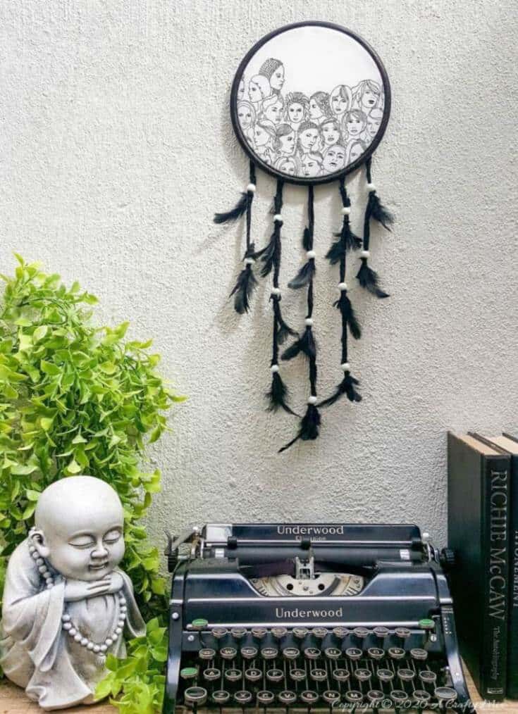 How to make a gorgeous paper napkin dream catcher. Easy craft idea to add to your home decor #DreamcatcherDIY #Napkinrepurpose #ACraftyMix #InThisTogether #BlackandWhite #HomeDecor #DreamcatcherCraft #TransferAdhesive #PaperNapkinCraft