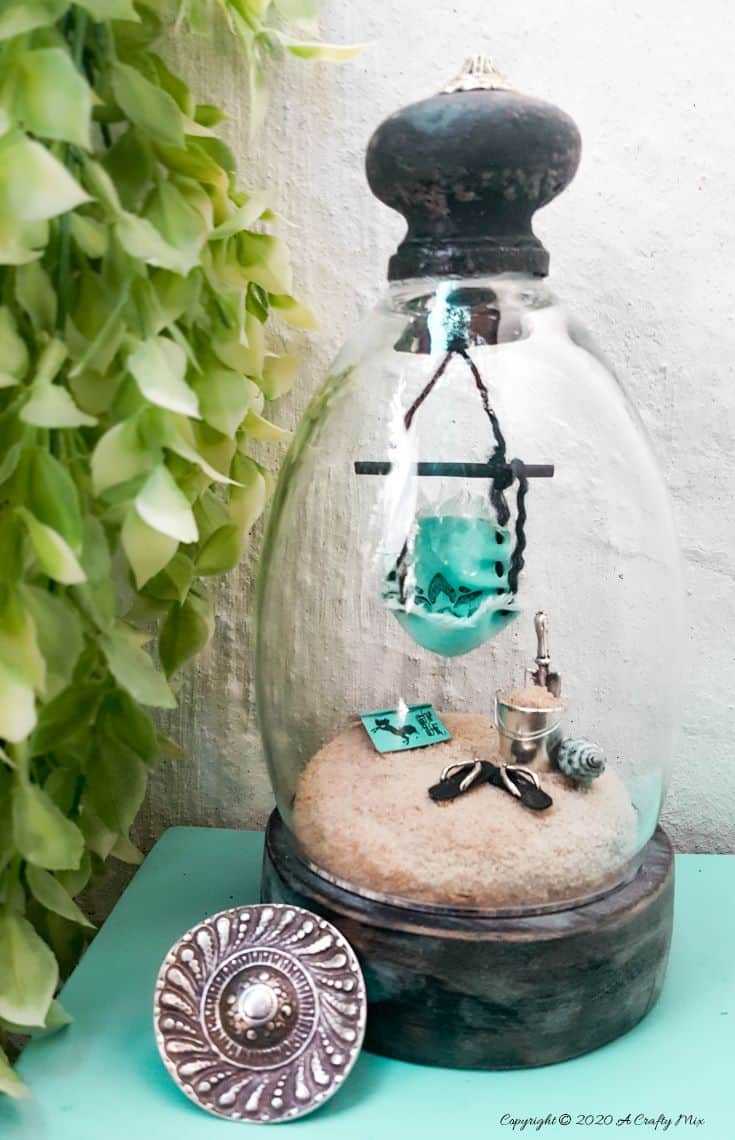 How to turn a broken wine glass into a fairy garden cloche #FairyGarden #FairyGardenIdeas #ACraftyMix #FairyGardenDIY #FairyBeachDIY #FairyGardenDesigns #ClocheDecor #ClocheIdeas #WineGlassCloche #ClocheDIY #WineGlassRepurpose #UnicornSPiT