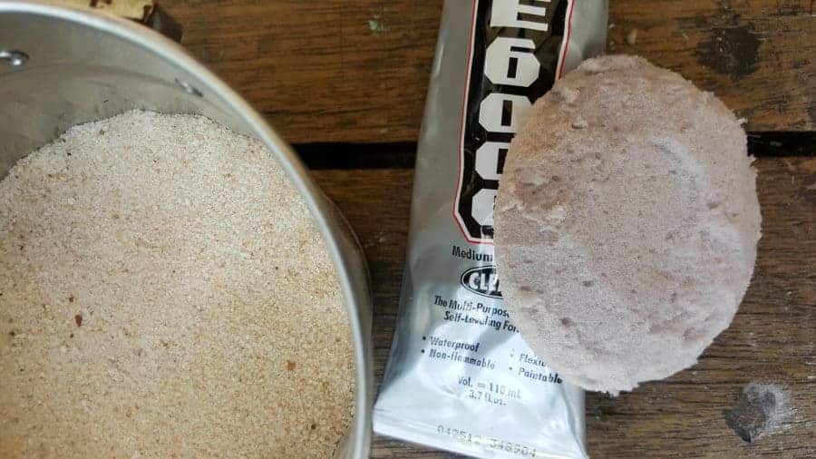 Adding the beach sand to  the fairy garden cloche #FairyGarden #FairyGardenIdeas #ACraftyMix #FairyGardenDIY #FairyBeachDIY #FairyGardenDesigns #ClocheDecor #ClocheIdeas #WineGlassCloche #ClocheDIY #WineGlassRepurpose #UnicornSPiT