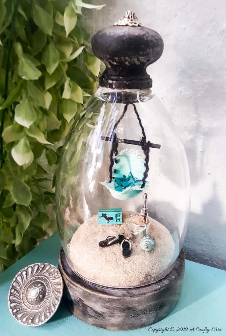 How to turn a broken wine glass into a fairy garden cloche #FairyGarden #FairyGardenIdeas #ACraftyMix #FairyGardenDIY #FairyBeachDIY #FairyGardenDesigns #ClocheDecor #ClocheIdeas #WineGlassCloche #ClocheDIY #WineGlassRepurpose #UnicornSPiT