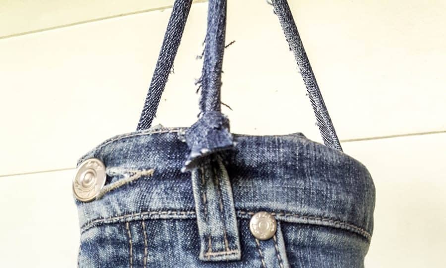 Cut strips of the denim to hand the upcycled denim wind chime #DIYDenim #DenimIdeas #DenimMobile #DenimUpcycleIdeas #ACraftyMix #DenimUpcycle #DIYWindChime #TinCanRecycle #TinCanMobile #DenimWindChime