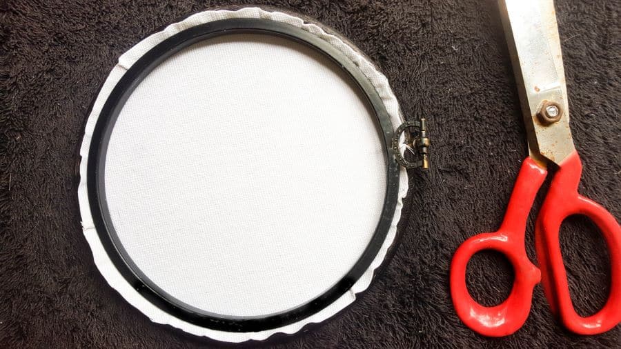Place the paper napkin transfer inside the embroidery hoop and trim away the excess #DreamcatcherDIY #Napkinrepurpose #ACraftyMix #InThisTogether #BlackandWhite #HomeDecor #DreamcatcherCraft #TransferAdhesive #PaperNapkinCraft