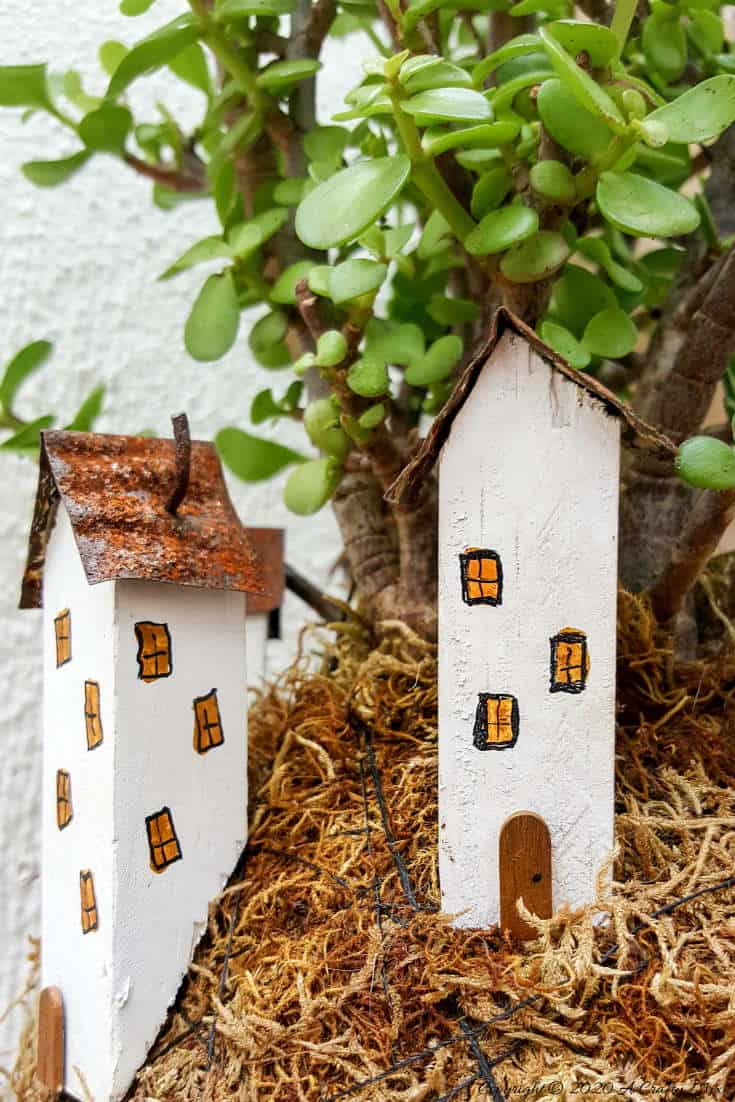 Take your moss ball string garden to the next level with this cute kokedama fairy village. Easy to make and customize. #EcoFriendly #Kokedama #FairyVillage #ACraftyMix #EasyGardenCraft #MossBalls #SpekBoom #kokedamaIdeas #StringGarden #IndoorPlants