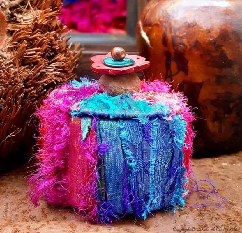 Don&rsquo;t throw that empty duct tape roll away until you&rsquo;ve seen how easy it is to turn it into this gorgeous boho storage box. #DuctTape #StorageIdeas #ACraftyMix #RepurposeIdeas #BohoDIYIdeas #RecycledStorage