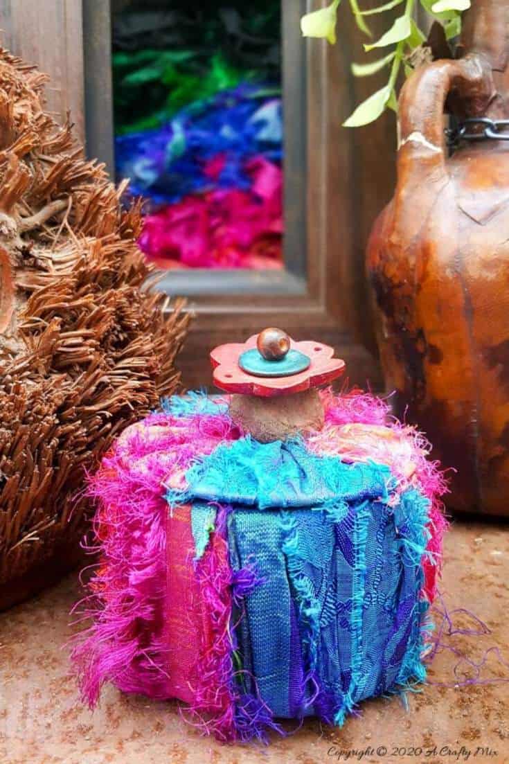 Don&rsquo;t throw that empty packing tape roll away until you&rsquo;ve seen how easy it is to turn it into this gorgeous boho storage. They make great gift boxes too. #DuctTape #StorageIdeas #ACraftyMix #RepurposeIdeas #BohoDIYIdeas #RecycledStorage #packingTape