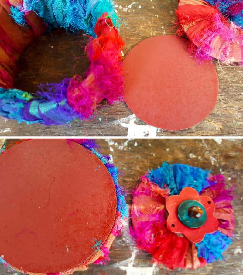 Paint the bottom circle and glue it onto the fabric covered duct tape roll