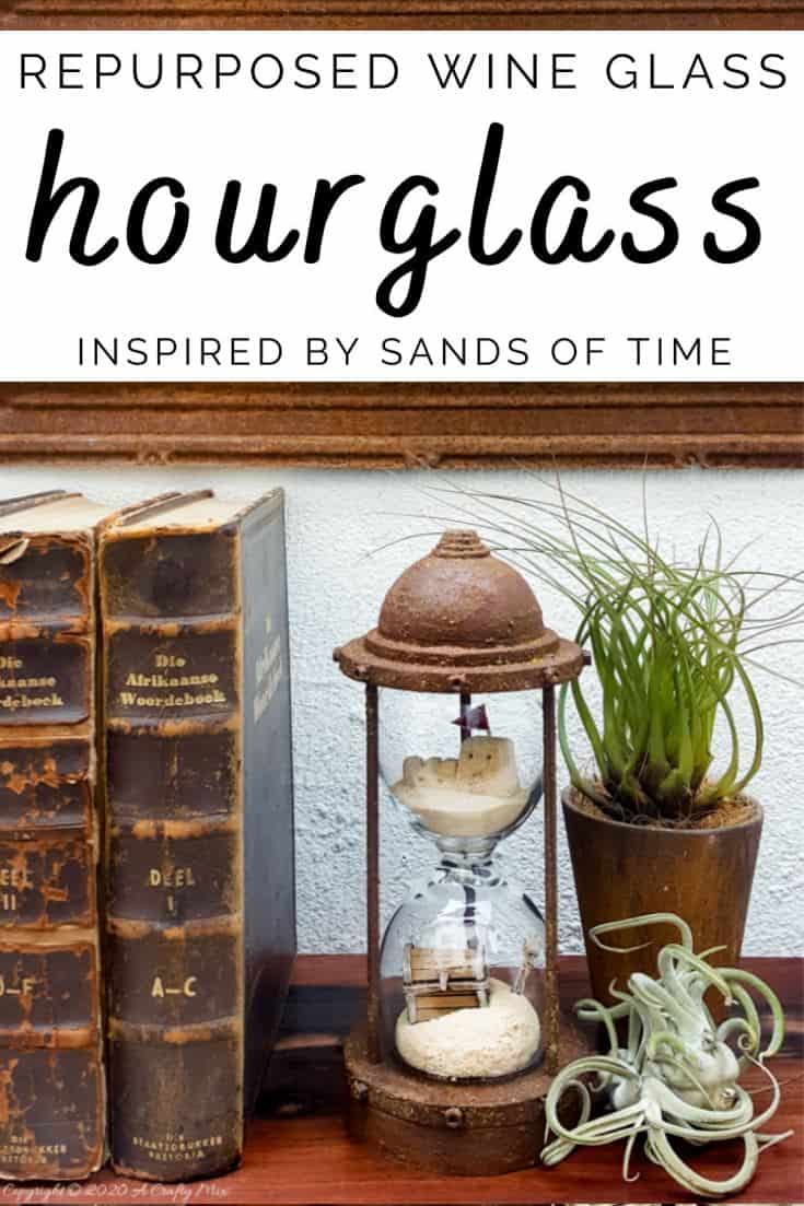 Turn broken wine glasses into this unique "Sands of Time" inspired hourglass. The tutorial includes how to make miniature sandcastles and a tiny treasure chest. #wineglassrepurpose #SandsofTime #uniquedecor #acraftymix #hourglassdecor