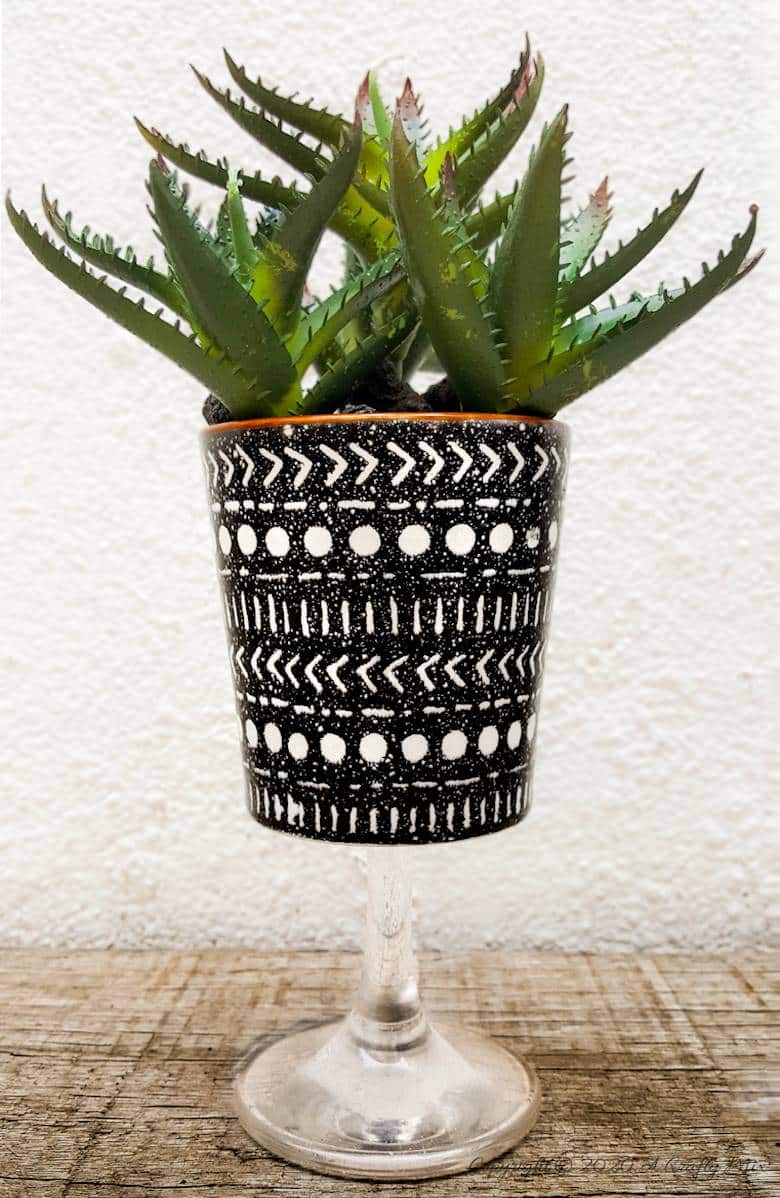 Turn trash into treasure and add a touch of class and whimsy to your d&eacute;cor with these gorgeous DIY broken wine glass stem planters. Easy to follow tutorial with step-by-step instructions