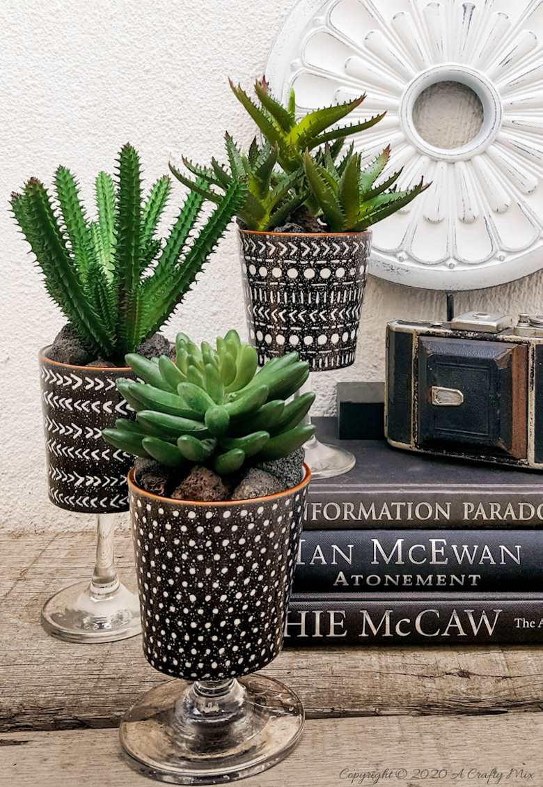 Turn trash into treasure and add a touch of class and whimsy to your d&eacute;cor with these gorgeous DIY broken wine glass stem planters. Easy to follow tutorial with step-by-step instructions
