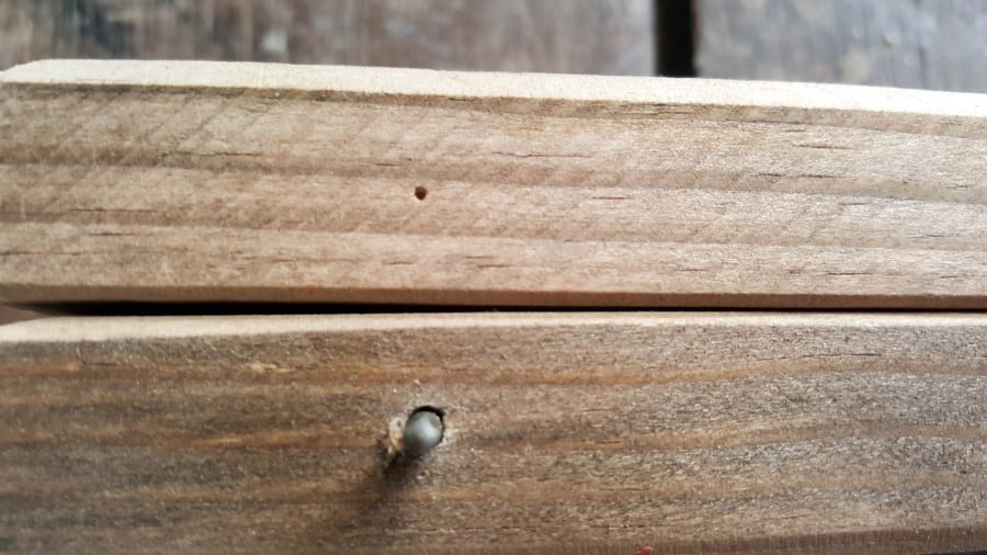 The sharp point of the nail will make a mark in the wood