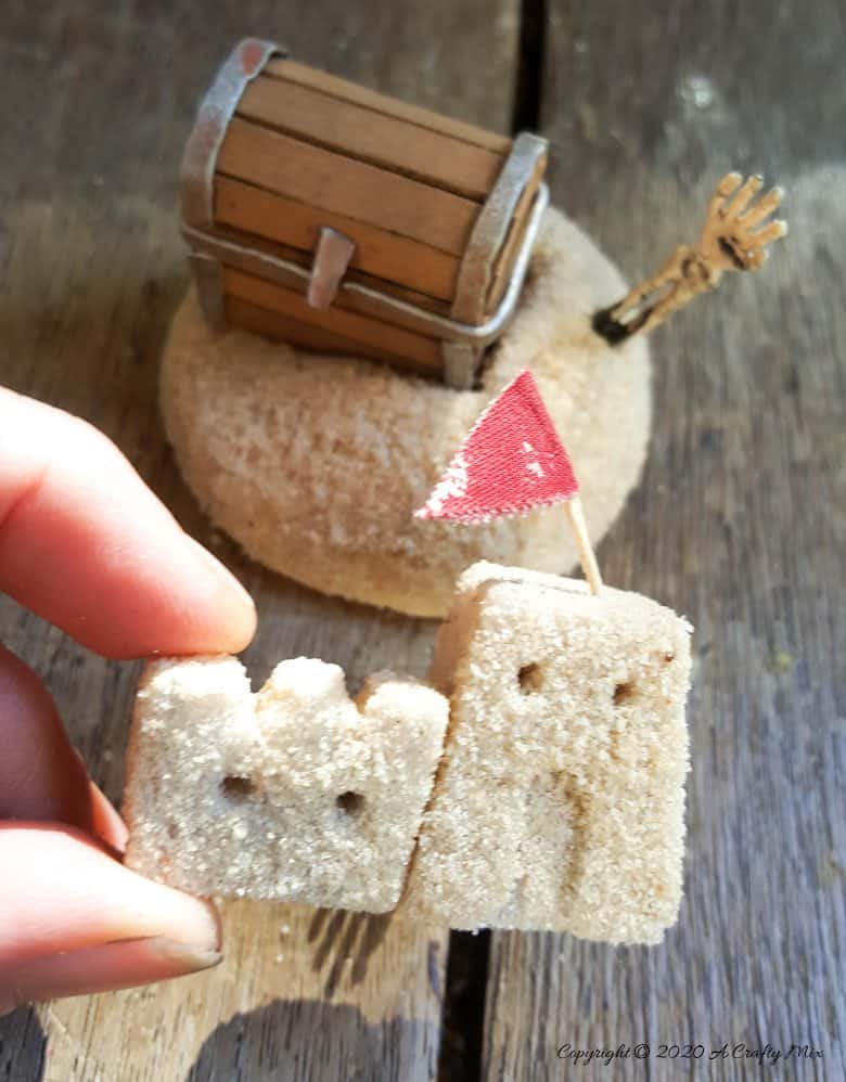 This tutorial will show you how to make miniature sandcastles and a tiny treasure chest. You'll also see how to turn broken wine glasses into this unique "Sands of Time" inspired hourglass.#wineglassrepurpose #SandsofTime #uniquedecor #acraftymix #hourglassdecor
