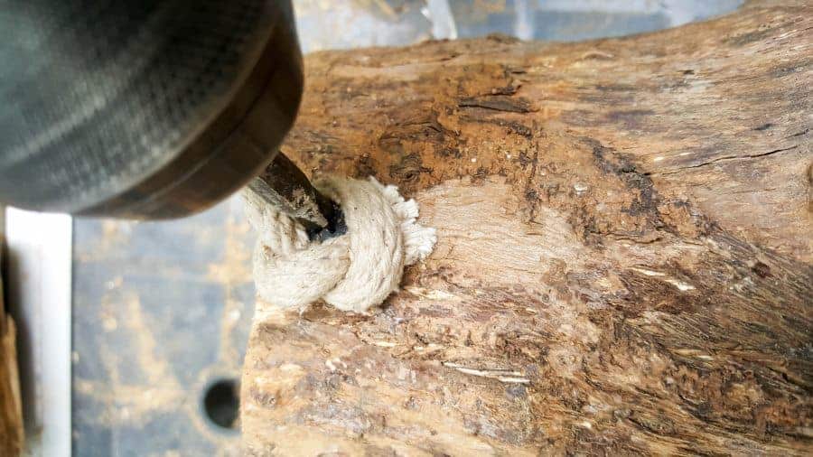 Tie a knot on both ends of the rope and screw it into the mug planter to form a handle