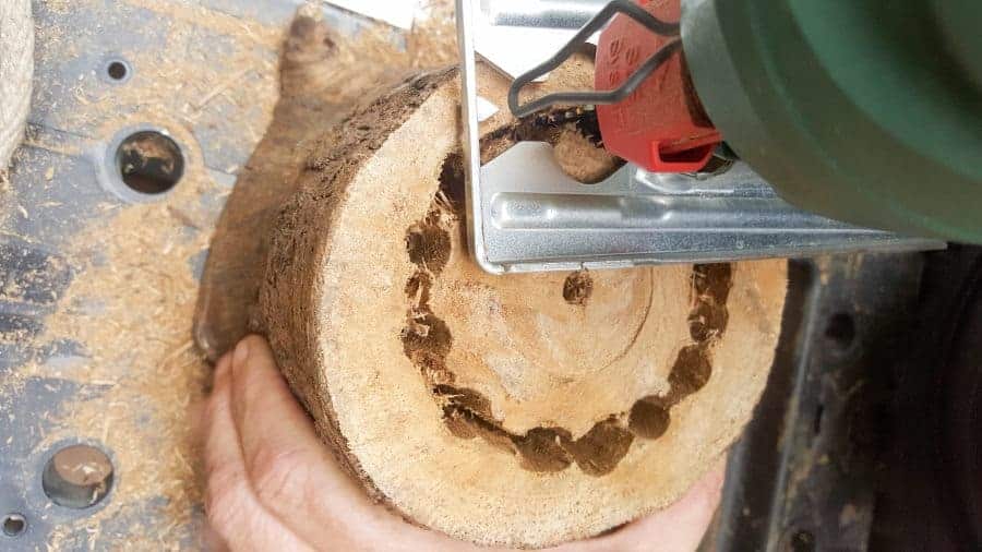 Place the jigsaw blade inside the holes and cut around