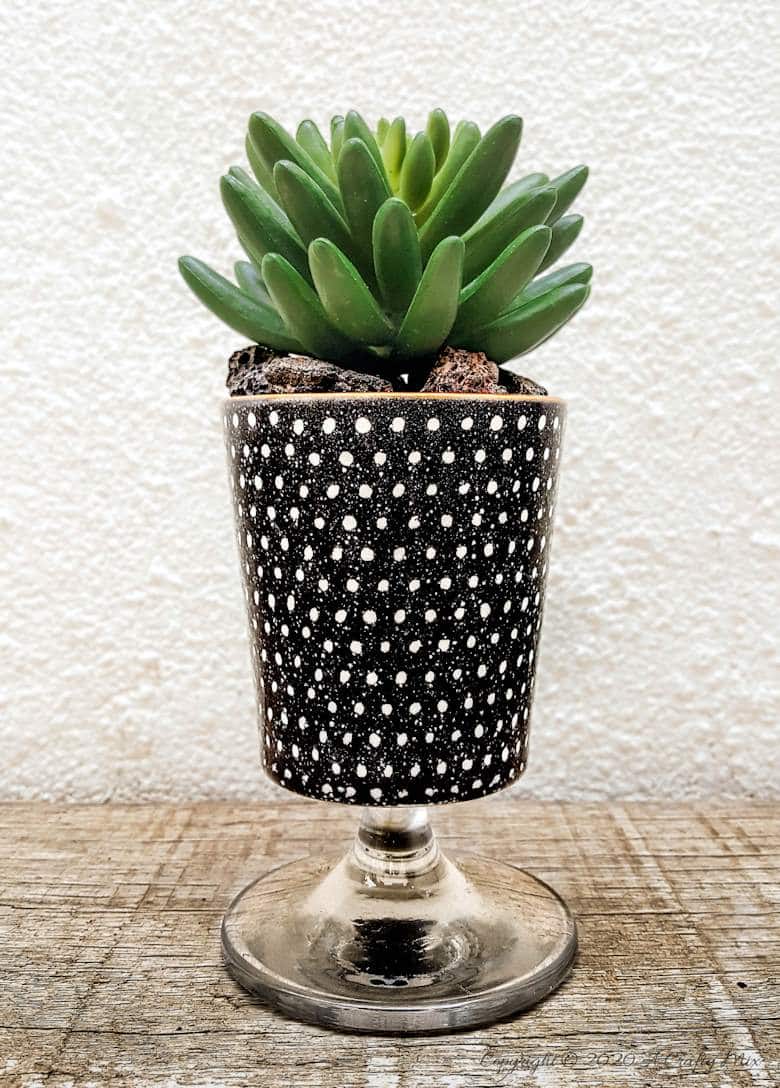 Turn trash into treasure and add a touch of class and whimsy to your d&eacute;cor with these gorgeous DIY broken wine glass stem planters. Easy to follow tutorial with step-by-step instructions