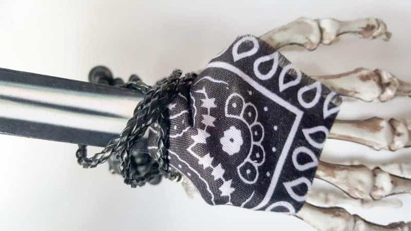 A close up of the bandana and bangles on the skeleton arm