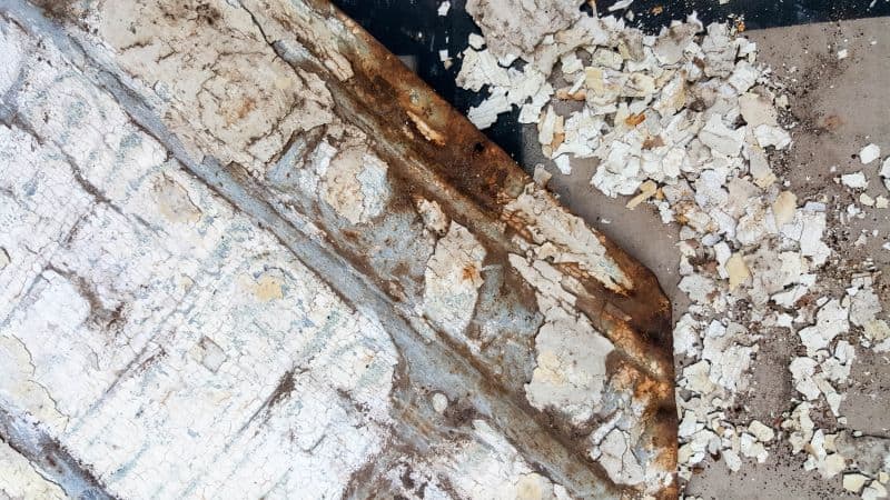 Bang and smack the tin ceiling tile to get rid of loose paint