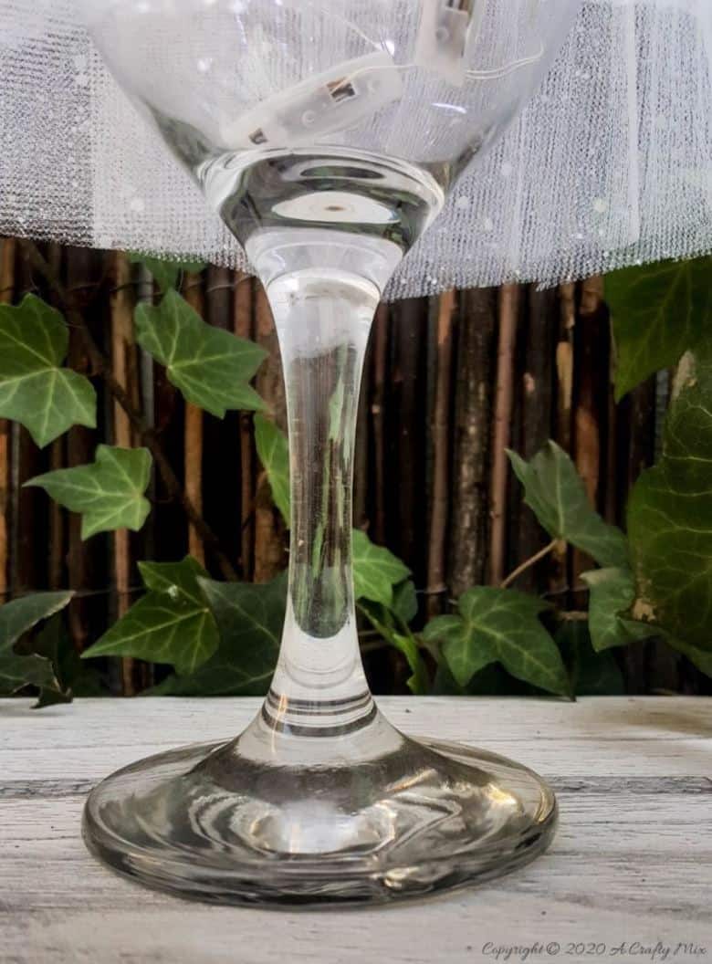 These budget-friendly wine glass Christmas trees are sure to brighten up your festive decor. #ChristmasDIY #ChristmasTree #ACraftyMix #ChristmasCrafts #TableDecor #WineGlassRepurpose