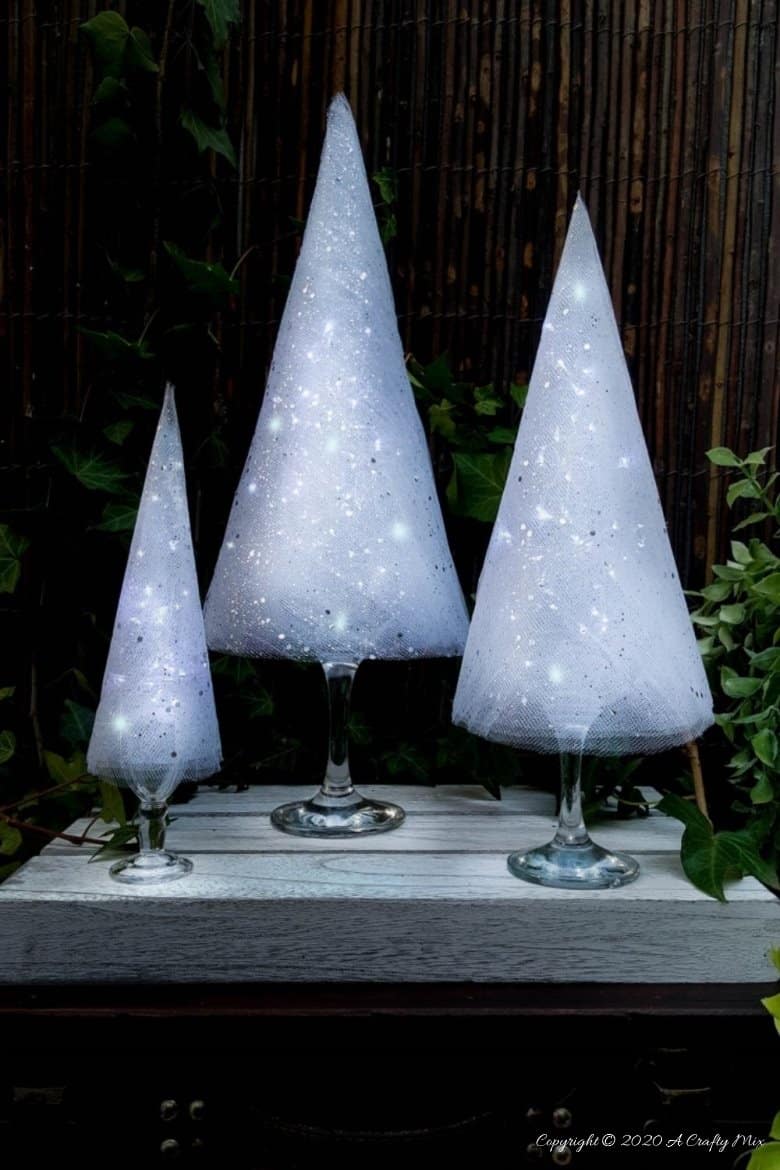 These budget-friendly wine glass Christmas trees are sure to brighten up your festive decor. #ChristmasDIY #ChristmasTree #ACraftyMix #ChristmasCrafts #TableDecor #WineGlassRepurpose