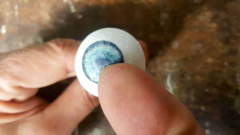 Use your thumb nail to flatten the iris picture onto the balls
