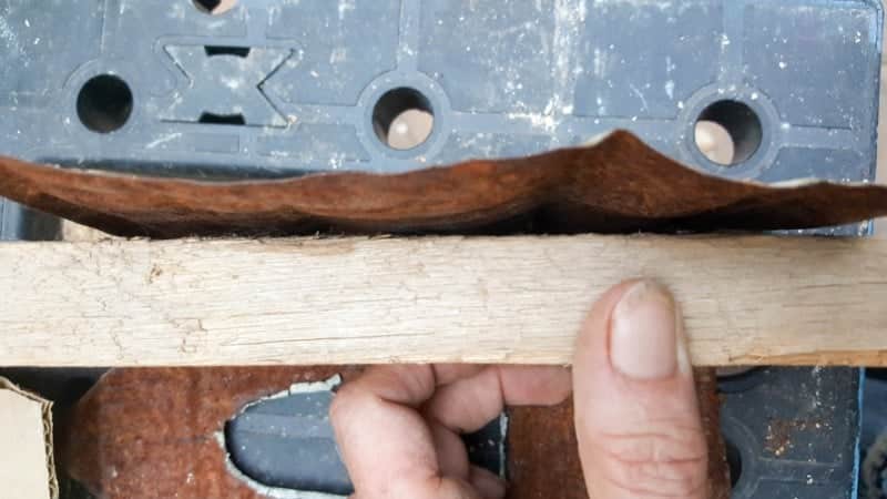 Use a block of wood to bend the sides of the bay window inwards