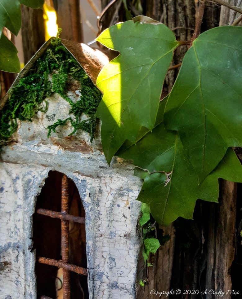 This easy to follow tutorial will show you to repurpose rusty scrap metal bits into a fairy bay window with lights. #FairyWindow #fairyCrafts #ACraftyMix #ScrapMetalRepurpose #TinCeilingTiles