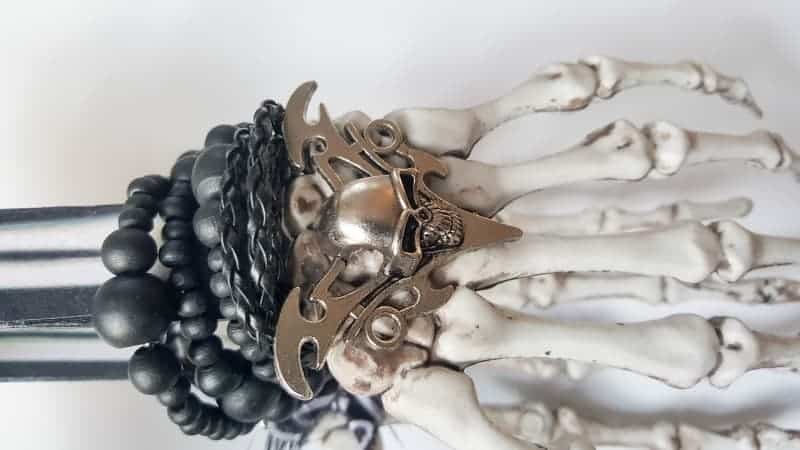 A close up of the skull and bangles on the skeleton arm
