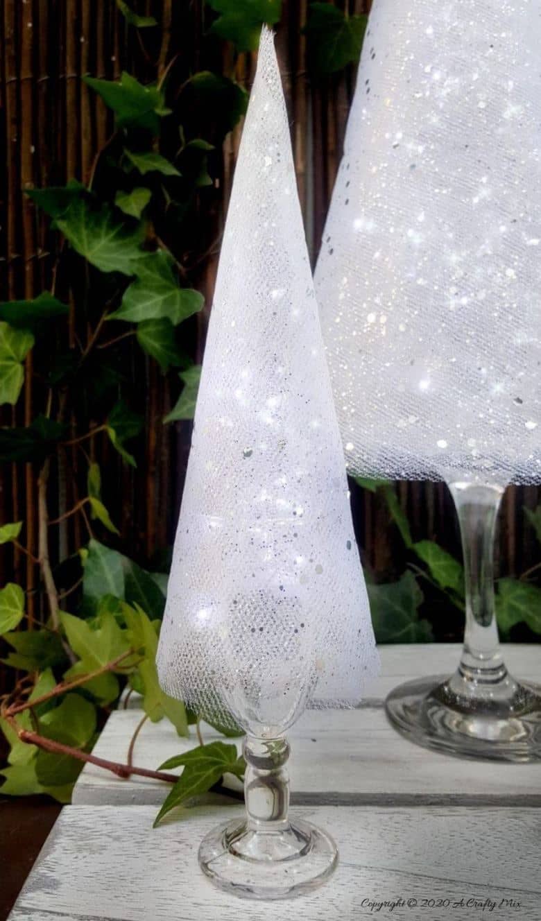 These budget-friendly wine glass Christmas trees are sure to brighten up your festive decor. #ChristmasDIY #ChristmasTree #ACraftyMix #ChristmasCrafts #TableDecor #WineGlassRepurpose