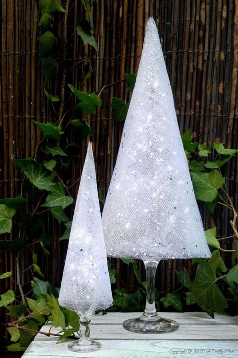 These budget-friendly wine glass Christmas trees are sure to brighten up your festive decor. #ChristmasDIY #ChristmasTree #ACraftyMix #ChristmasCrafts #TableDecor #WineGlassRepurpose