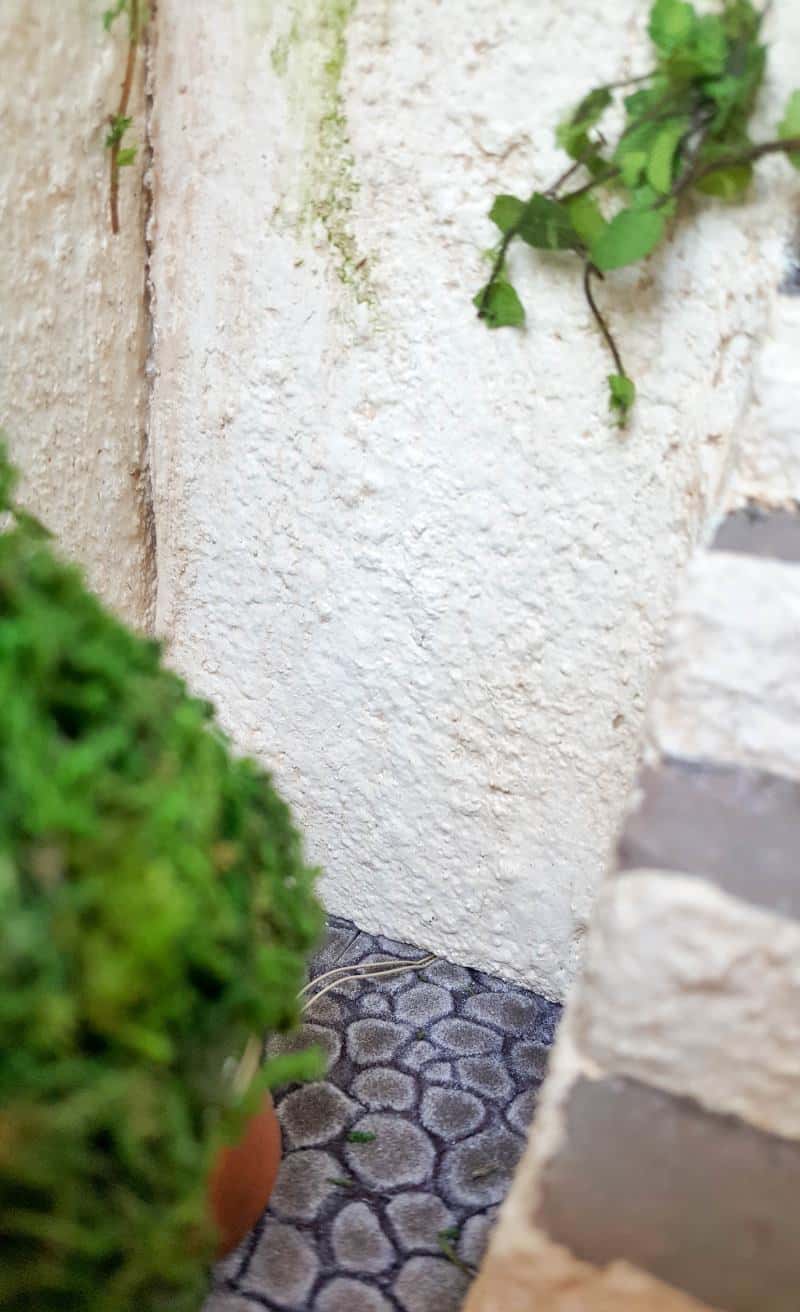 Glue the cobblestones down and add the vines and moss