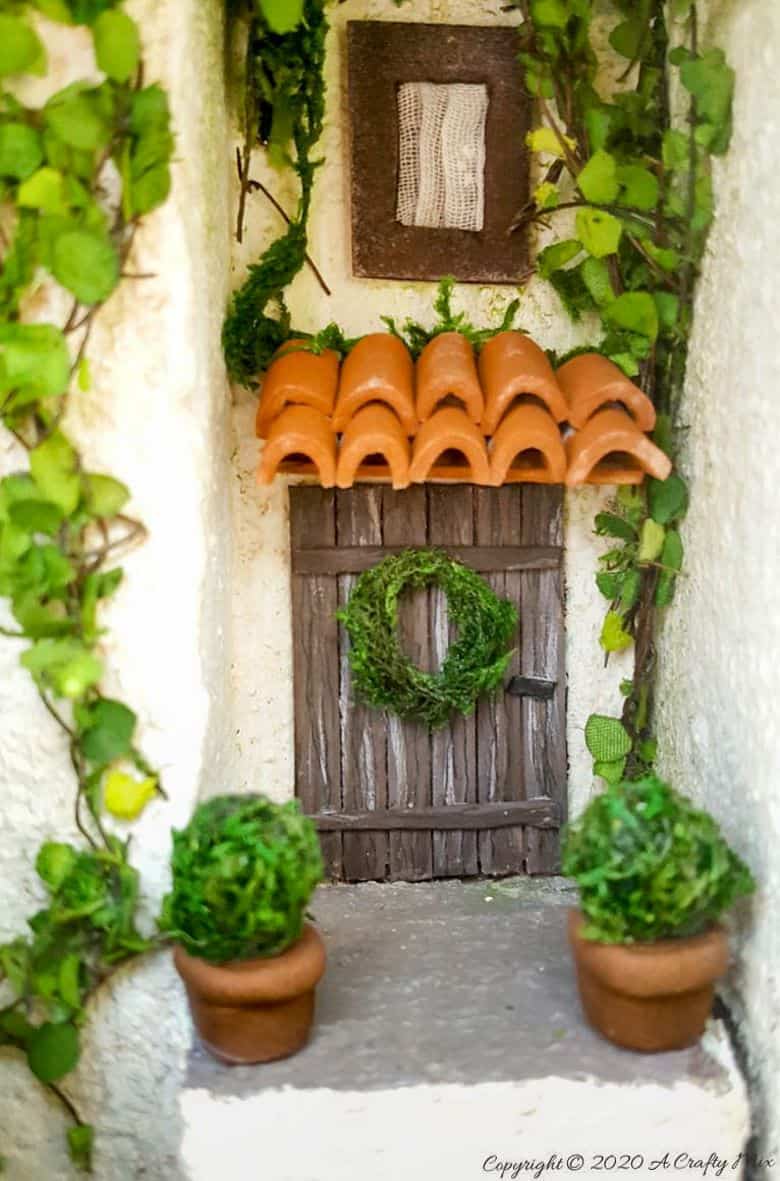 Add a little festive magic to your bookshelf with a book nook. These gorgeous miniature scenes captured in a book are trending right now and putting one together is easier than you think and whole bunch of fun too. #booknook #booktome #ACraftyMix #makingminiatures