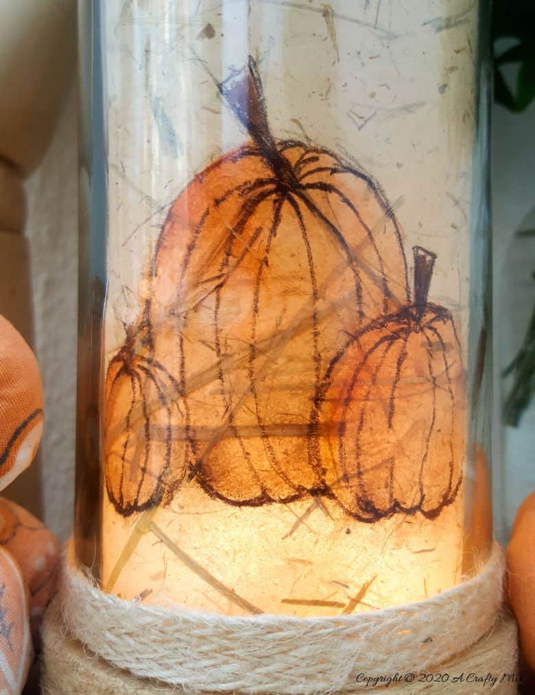 Take your glass bottle light to a whole new level with this DIY idea. A quick and easy way to repurpose and customize ONE bottle to fit any occasion or season with swappable art inserts. And you&rsquo;ll have loads of fun coming up with new images to put inside too. #bottlelight #winebottlelights #acraftymix #bottlerepurpose #bottlecrafts