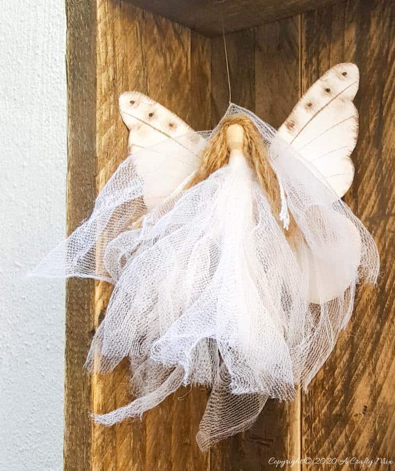 This easy to follow tutorial will show you how to make a rustic clothespin Nativity scene out of fabric scraps and wooden pegs. The tutorial includes a &ldquo;free to download&rdquo; printable for the angel wings and detailed instructions to make Mary, Joseph, the Angel and baby Jesus #ClothesPinCrafts #DIYNativity #WoodenPegCrafts #ACraftyMix #ChristmasCrafts #NativityScene