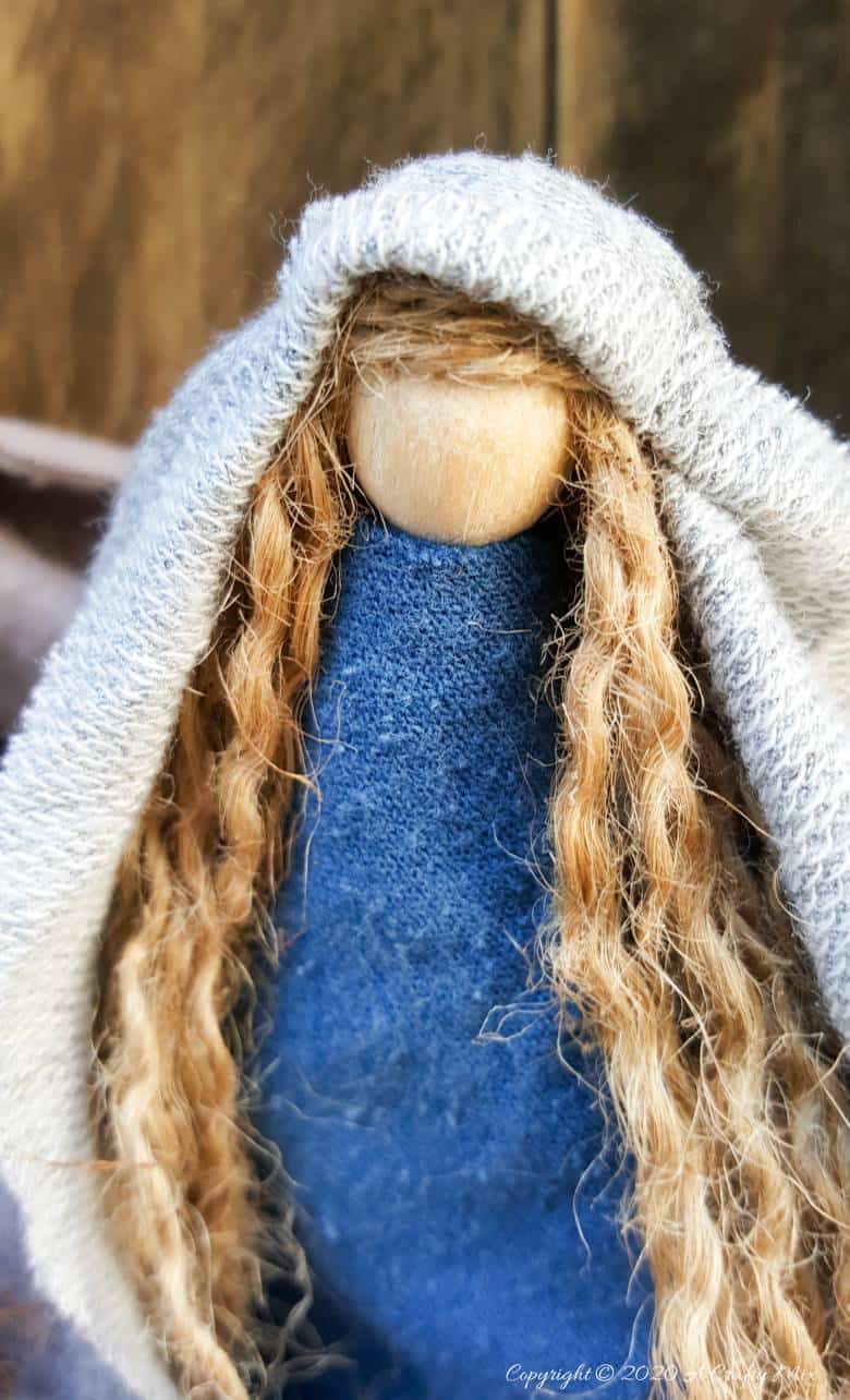 This easy to follow tutorial will show you how to make a rustic clothespin Nativity scene out of fabric scraps and wooden pegs. The tutorial includes a &ldquo;free to download&rdquo; printable for the angel wings and detailed instructions to make Mary, Joseph, the Angel and baby Jesus #ClothesPinCrafts #DIYNativity #WoodenPegCrafts #ACraftyMix #ChristmasCrafts #NativityScene