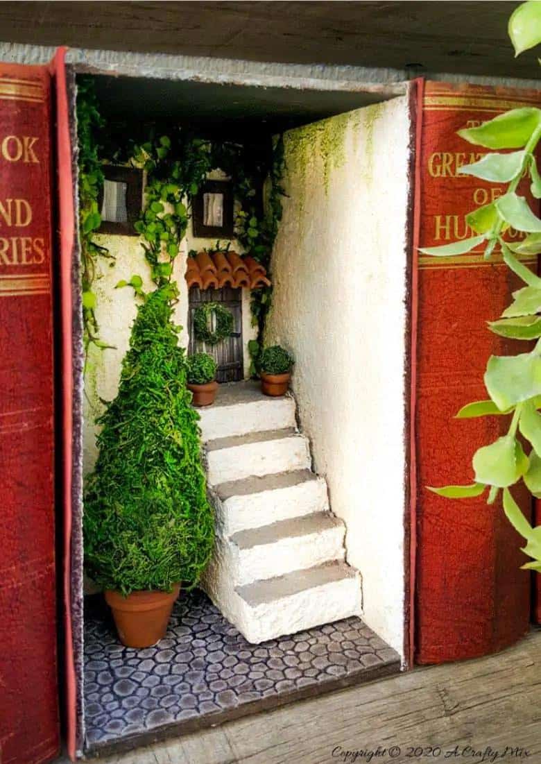 Add a little festive magic to your bookshelf with a book nook. These gorgeous miniature scenes captured in a book are trending right now and putting one together is easier than you think and whole bunch of fun too. #booknook #booktome #ACraftyMix #makingminiatures