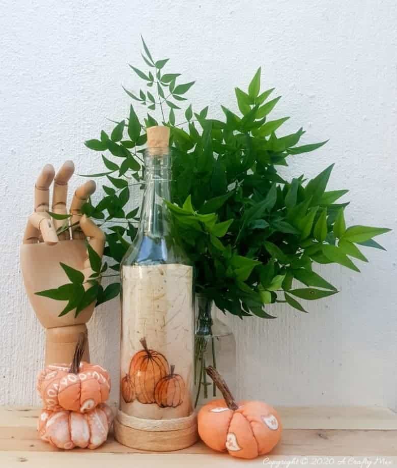Take your glass bottle light to a whole new level with this DIY idea. A quick and easy way to repurpose and customize ONE bottle to fit any occasion or season with swappable art inserts. And you&rsquo;ll have loads of fun coming up with new images to put inside too. #bottlelight #winebottlelights #acraftymix #bottlerepurpose #bottlecrafts
