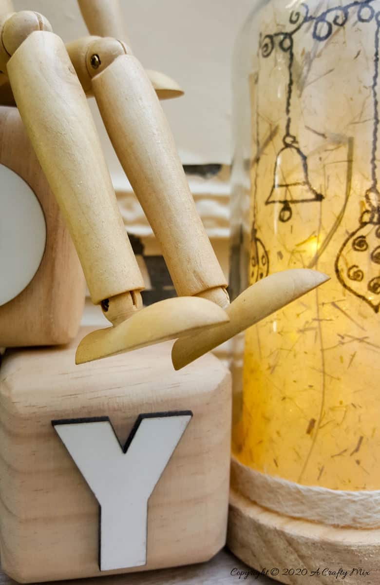 Take your glass bottle light to a whole new level with this DIY idea. A quick and easy way to repurpose and customize ONE bottle to fit any occasion or season with swappable art inserts. And you&rsquo;ll have loads of fun coming up with new images to put inside too. #bottlelight #winebottlelights #acraftymix #bottlerepurpose #bottlecrafts