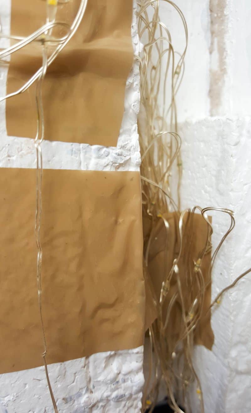 Tape the fairy lights to the back of the structure