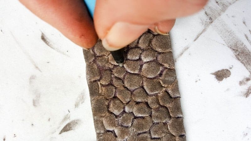 Trace around the cobblestones with a black pen to mimic grout