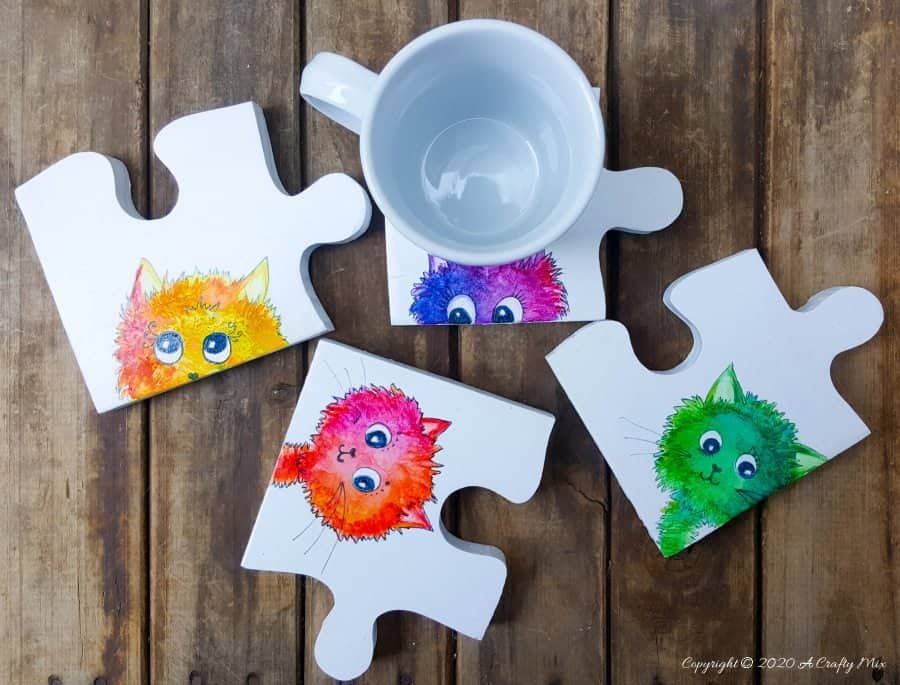 Best DIY Gift Idea EVER!!! Curious Kitty Puzzle Coasters that double up as a platter when you put them all together. The full tutorial will show you how to make your own and includes a free template for the puzzle as well as all four kitties. #PuzzleCoasters #DIYGiftIdea #ACraftyMix #PuzzlePlatter ##DIYPuzzle #FreePrintable