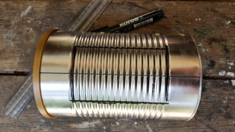 Use a permanent marker to mark where to cut the tin can